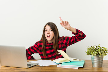 Young teenager going back to her routine doing homeworks having an idea, inspiration concept.