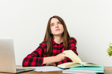 Young teenager going back to her routine doing homeworks tired of a repetitive task.