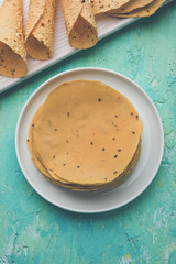 Gujarati papad or papadum in raw dried form with roasted cone, roll and flat variation