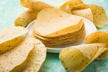 Gujarati papad or papadum in raw dried form with roasted cone, roll and flat variation