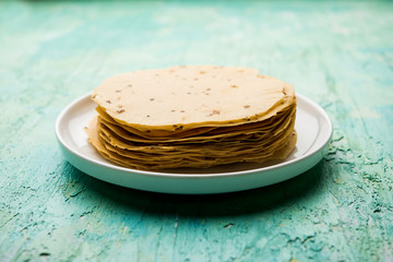 Gujarati papad or papadum in raw dried form with roasted cone, roll and flat variation