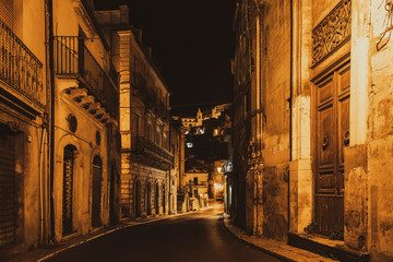 Narrow typical italian street of baroque city Ragusa Ibla at night, Sicily, south Italy