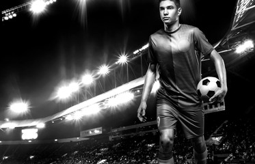 Fototapeta na wymiar Black and white photo of teenager - soccer player. Man in football sportswear after game with ball. Sport concept.