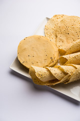 Gujarati papad or papadum in raw dried form with roasted cone, roll and flat variation