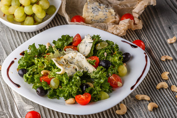 salad provence with blue cheese on wooden table