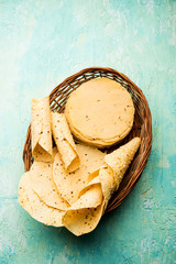 Gujarati papad or papadum in raw dried form with roasted cone, roll and flat variation