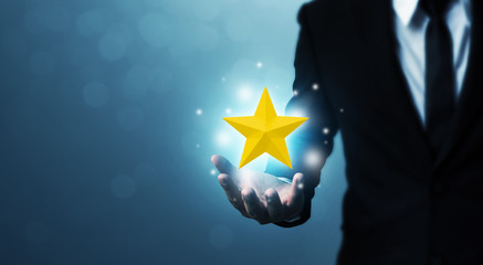 Businessman hands hold a five-star gold shape. The best excellent business services rating customer...