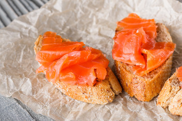 Bruschetta with smoked salmon on crumpled baking paper