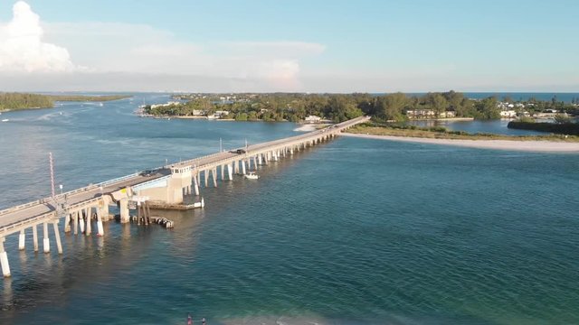 Aerial of Longboat Pass bridge leading to Longboat Key in this majestic blue seas scene.  An island time feeling near home.  The pass is a favorite for fishing and socializing.