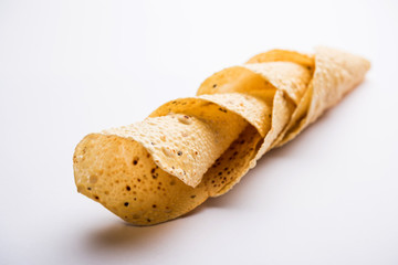 Gujarati papad or papadum in raw dried form with roasted cone, roll and flat variation