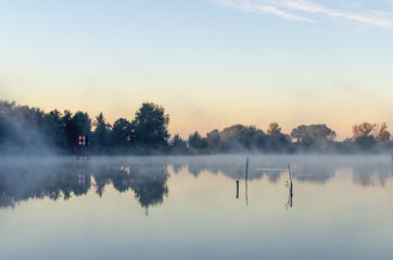 Morning landscape with fog over the lake