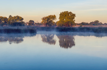 Fototapeta na wymiar Morning landscape with fog over the lake