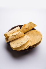 Gujarati papad or papadum in raw dried form with roasted cone, roll and flat variation
