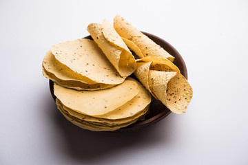 Gujarati papad or papadum in raw dried form with roasted cone, roll and flat variation