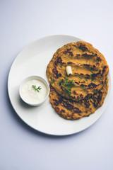 Thalipeeth is a type of savoury multi-grain pancake popular in Maharashtra, India served with curd/butter or ghee