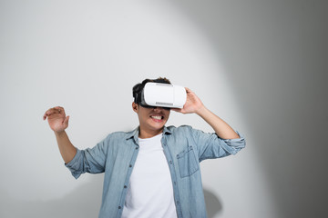 Man wearing virtual reality goggles. Studio shot, white background, isolated