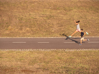 boy and girl running on a field