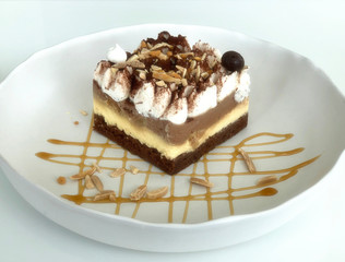 banoffee pie cake decorate in white dish ready to serve on white table