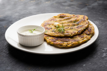 Thalipeeth is a type of savoury multi-grain pancake popular in Maharashtra, India served with curd/butter or ghee