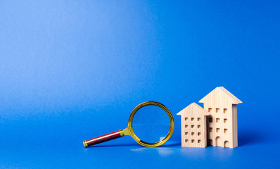 figures of residential buildings and magnifying glass. Home appraisal. Property valuation. Realtor services for renting and buying an apartment or house. House searching concept. Real estate