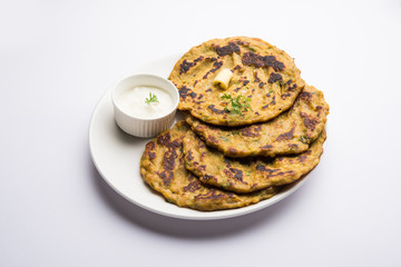 Thalipeeth is a type of savoury multi-grain pancake popular in Maharashtra, India served with curd/butter or ghee