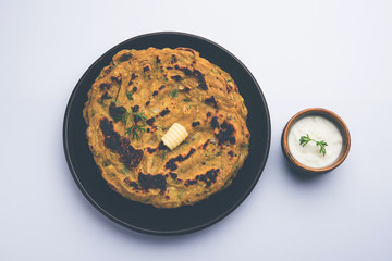 Thalipeeth is a type of savoury multi-grain pancake popular in Maharashtra, India served with curd/butter or ghee