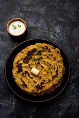 Thalipeeth is a type of savoury multi-grain pancake popular in Maharashtra, India served with curd/butter or ghee