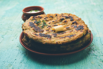 Thalipeeth is a type of savoury multi-grain pancake popular in Maharashtra, India served with curd/butter or ghee