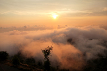 Beautiful structure of clouds on sky, mountain landscape with dense fog at sunset on horizon of beauty natural environment. Panorama of amazing sunrise view show sun rays through clouds over mountain.