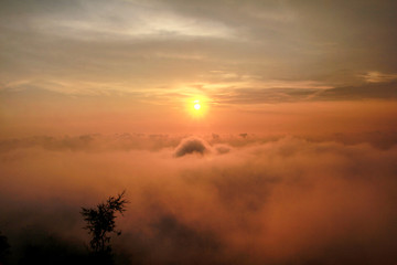 Beautiful structure of clouds on sky, mountain landscape with dense fog at sunset on horizon of beauty natural environment. Panorama of amazing sunrise view show sun rays through clouds over mountain.