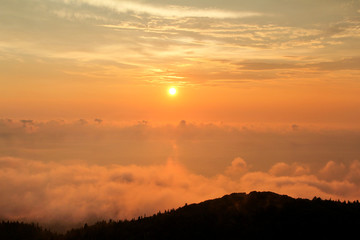 Beautiful structure of clouds on sky, mountain landscape with dense fog at sunset on horizon of beauty natural environment. Panorama of amazing sunrise view show sun rays through clouds over mountain.