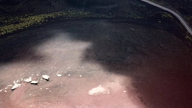 Aerial drone slowly panning up above the crater of the Etna vulcano near Catania in Sicily, Italy.