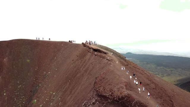 Aerial drone shot showing people walking up the Etna vulcano near Catania in Sicily, Italy.