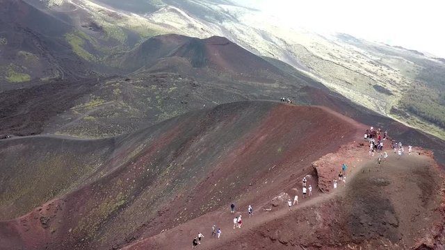 Rotating drone shot going over the Etna near Catania in Sicily, Italy,  showing people walking up the vulcano.