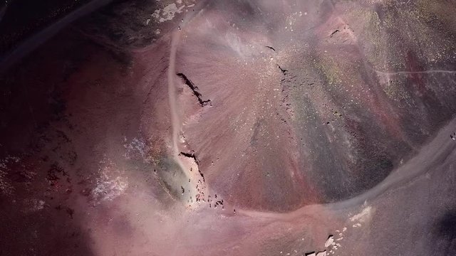 Rotating aerial drone going away from the crater of the Etna vulcano near Catania in Sicily, Italy.