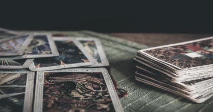 BRUVOLL, NORWAY - MARCH 23, 2011: Occult mystic tarot deck and old tarot cards laying on table for a magical pagan ritual psychic destiny reading - Concept of supernatural, witchcraft or destiny