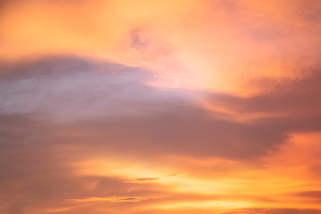 Landscape of the dramatic sunset on the sky with golden clouds in the evening. Colorful on the sky in twilight with clouds.