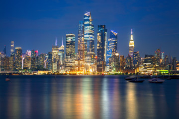 Fototapeta na wymiar Manhattan night lights reflected in Hudson