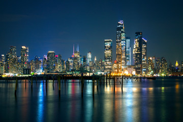 Obraz na płótnie Canvas Manhattan night lights reflected in Hudson