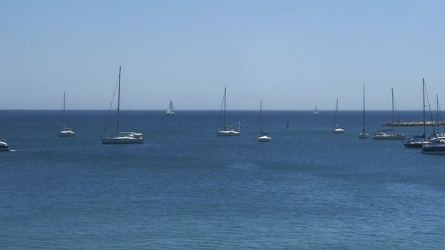 Train ride window view of yachts and sailboats at Cascais Bay, Lisbon, Portugal also known as the Costa Verde - Green Coast