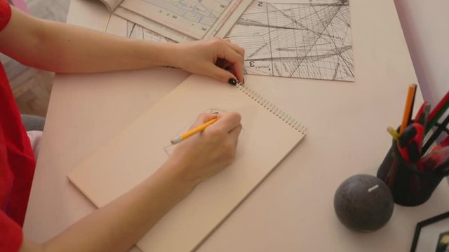 Close up woman draws a pencil on paper at home. Female fashion designer drawing sketches the dress. Fashion designer drawing and paint. Study design tutorial animator illustrator work freelance