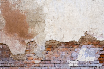 Old Weathered Brick Wall With Beaten Pieces Of Whitewash, Putty And Plaster. Fragment Of Wall Surface Of Historic Building With Chips, Cracks And Damages.