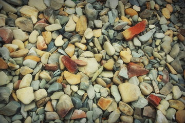 stone marine coastal texture background grey light red small pebbles