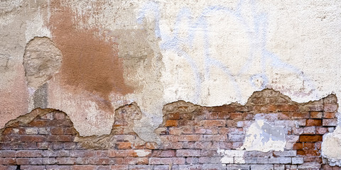 Background Of Old Vintage Dirty Brick Wall With Peeling Plaster, Texture. Shabby Building Facade With Damaged Plaster. Abstract Web Banner. Copy Space.
