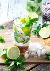 Fototapeta premium Mohito lime drinks on wooden with blur beach background