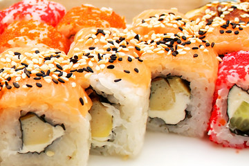 Sushi and rolls with fish, caviar, cheese, sesame seeds and rice. Close-up