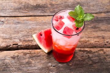 Glass of water melon soda drinks on wooden background. 