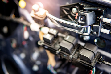 Obraz premium Car interior door handle and mirror button control panel without cover material inside of the racing car. Automobile industry concept