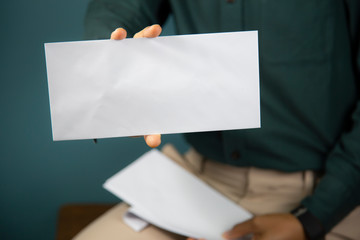 Hand holding  a blank piece of paper. Close up  white business card.