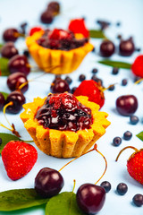 Small berry cake and ripe berries